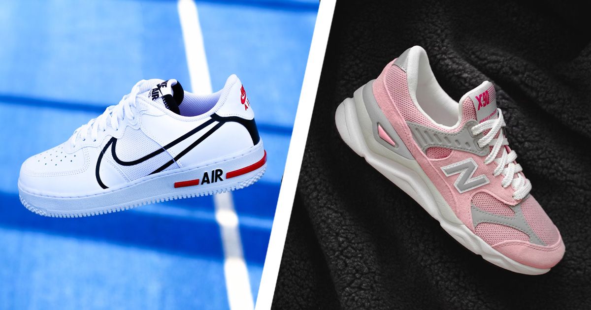 On one side of a diagonal white line, a white Nike low-top show featuring a large Swoosh outlined in black along the side and red trim. On the other side, a pink, grey, and white New Balance low-top on a fluffly black surface.