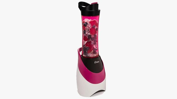 Best Blender Oster product image of a white and pink machine with berry's ready to mix in the cup.