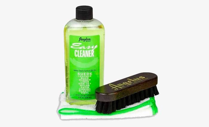 Best suede cleaner for shoes Angelus product image of a bottle containing light green cleaner, a dark brown brush, and a white cloth.