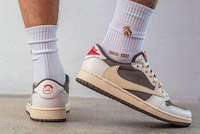 Travis Scott x Air Jordan 1 Low "Reverse Mocha" product image of a sail and brown suede pair of sneakers with reverse Swooshes.