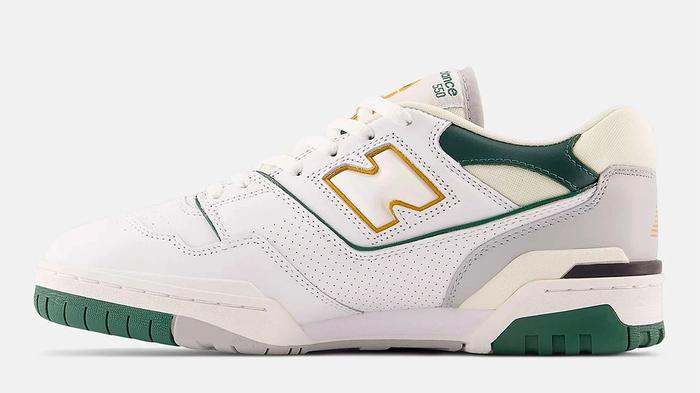 Best sneakers for winter New Balance 550 product image of a white leather sneaker with light grey, dark green, and mustard yellow accents.