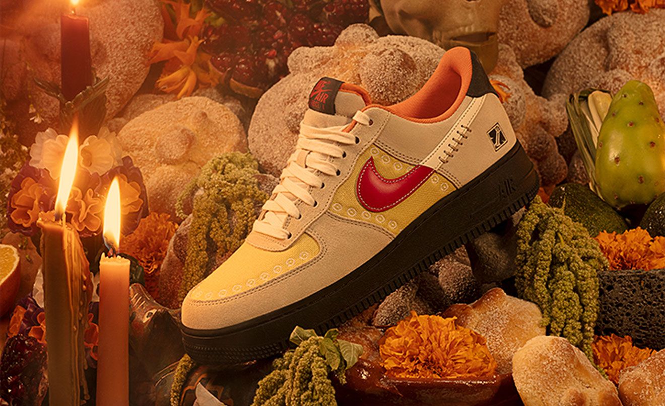Nike Air Force 1 "Somos Familia" product image of an embroidered and stitched sneaker dressed in light cream and yellow with a black midsole.