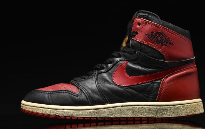 Air Jordan 1 "Bred" 1985 product image of a black, red, and white sneaker.