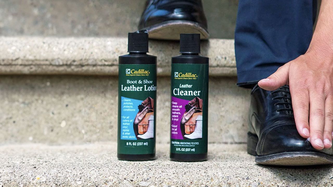 Image of two black bottles with green labels next to someone walking down a step in black leather shoes.