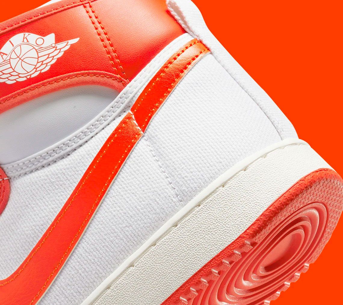 Air Jordan 1 KO "Syracuse" product image of a black pair of white sneakers with bright orange overlays.