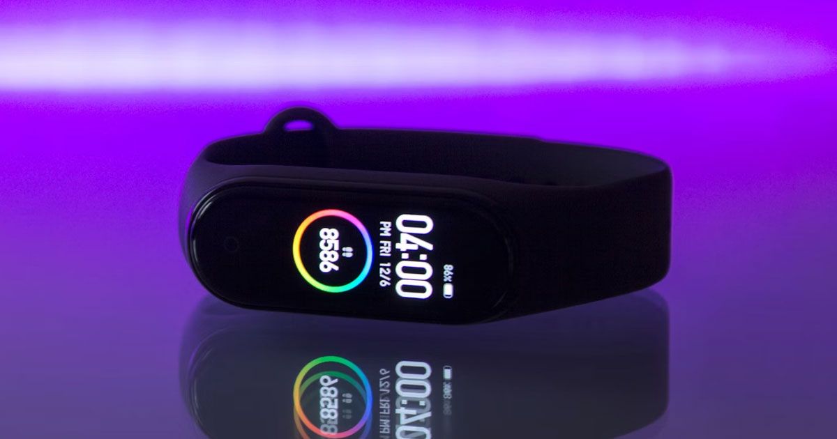A black, thin, Xiaomi fitness tracker with the time showcased in white and steps calculated on the display.