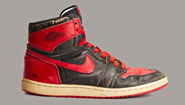 Air Jordan 1 High "Banned" colourway from 1985, featuring a red, black, and white colour scheme.