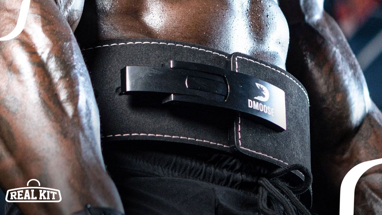 Someone in black shorts wearing an all-black DMoose weightlifting belt while lifting.