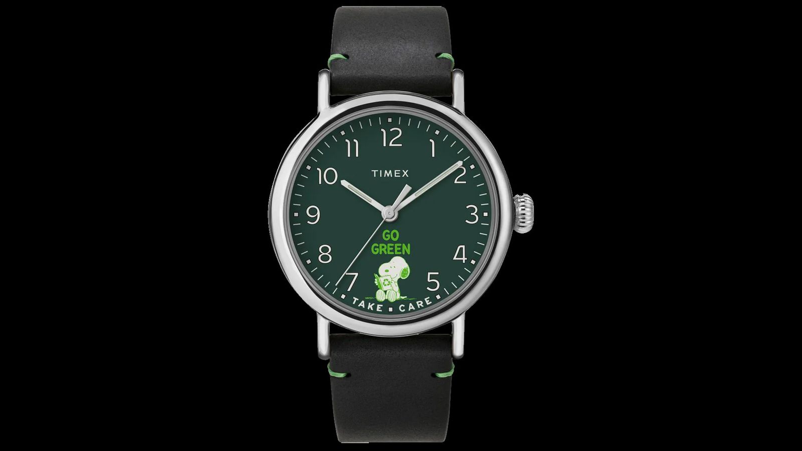 Timex Standard x Peanuts Take Care product image of a silver watch with a black strap with a green Snoopy graphic on the face.