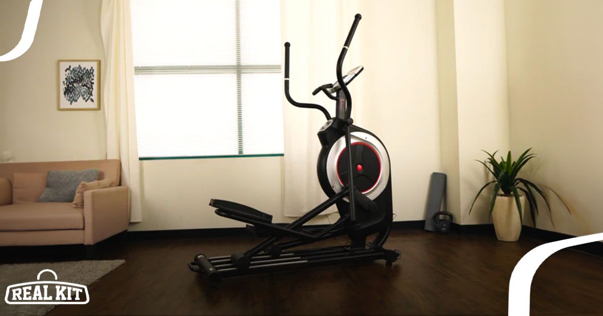 Image of a black elliptical with silver and red details in a light living room.
