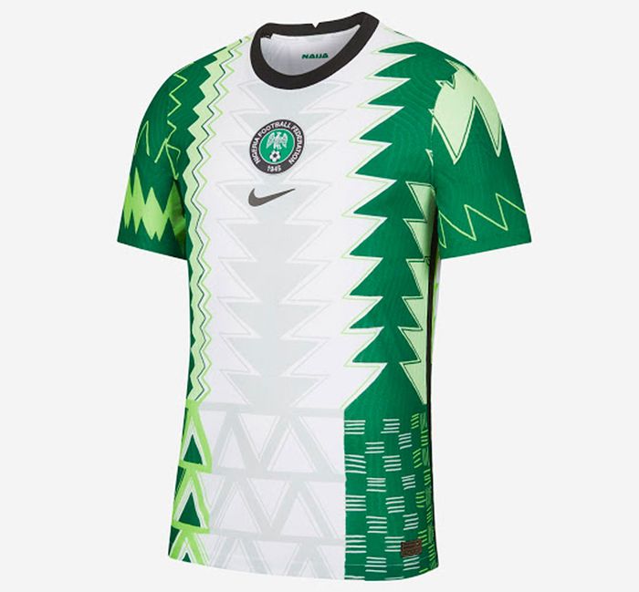 Best football kits 2021/22 Nigeria Home kit product image of a white shirt with various green details and patterns on the sides.
