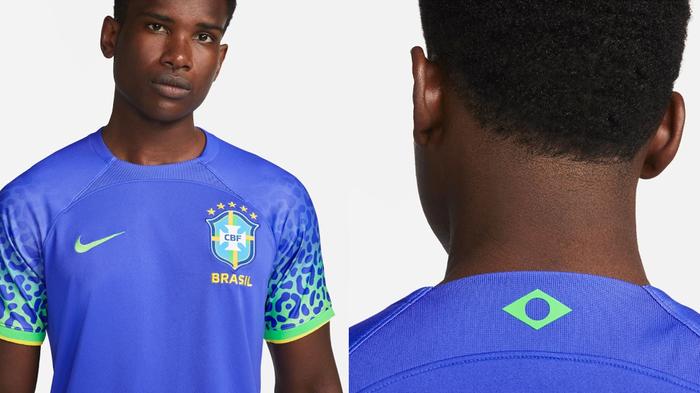 Brazil 2022 World Cup away kit product image of a blue shirt with a green jaguar print pattern on the sleeves.