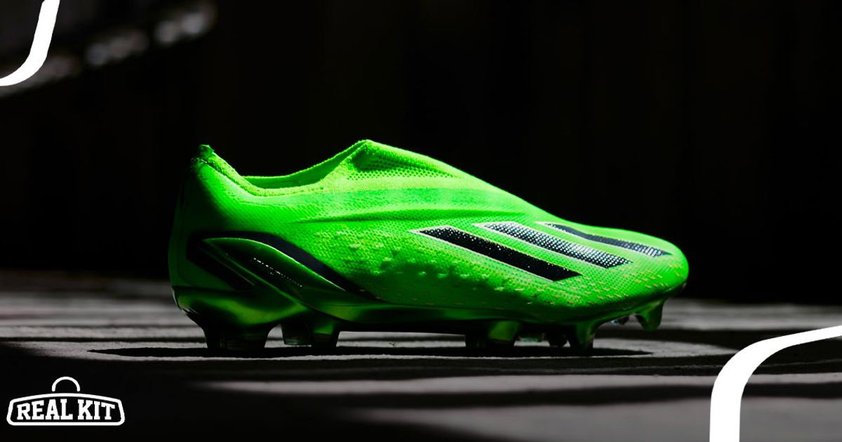 Image of a bright green adidas football boot featuring black stripes across the side in a dark room.