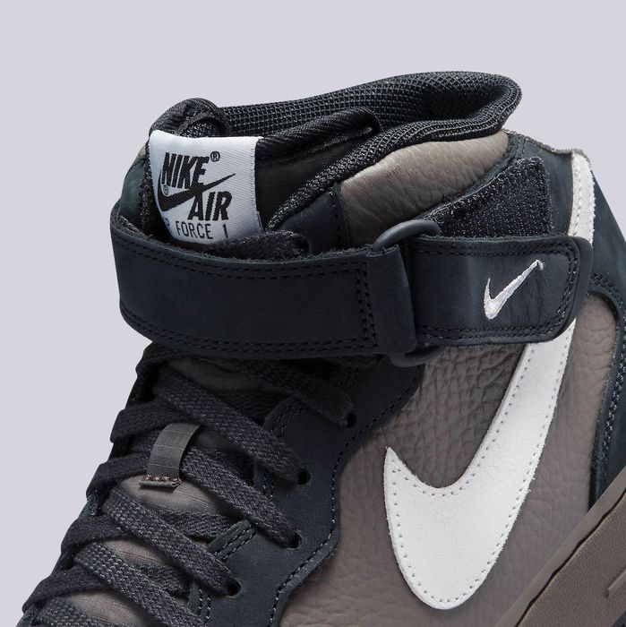 Nike Air Force 1 Mid "Berlin" product image of a black suede and brown leather sneaker with white details.