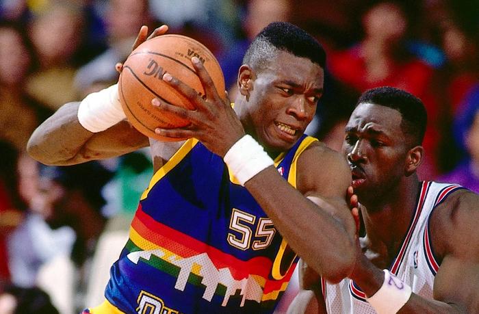 Best NBA jerseys of all time Denver Nuggets product image of Dikembe Mutombo wearing a blue strip with a rainbow city skyline across the centre.