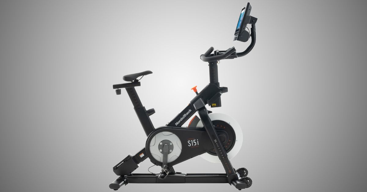 NordicTrack Commercial S15i product image of a black spin exercise bike with a silver flywheel and a head-up display.