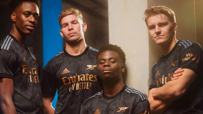 Arsenal adidas away kit product image of a black strip with copper accents.