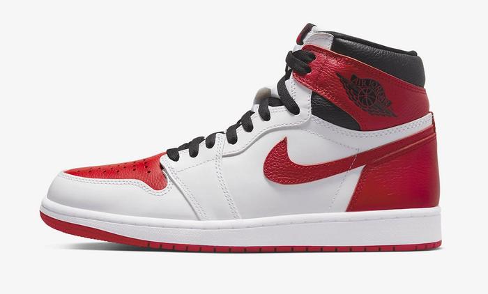Air Jordan 1 product image of a white leather sneaker with red and black accents.