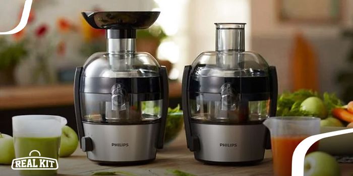 Image of two black and grey juicers next to green apples.