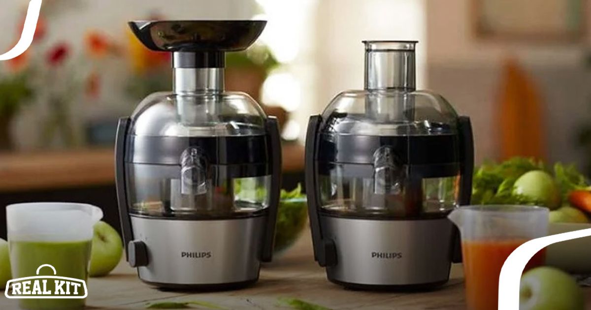 Image of two black and grey juicers next to green apples.