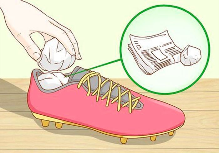 How to clean football boots cartoon image of red boots filled with newspaper.