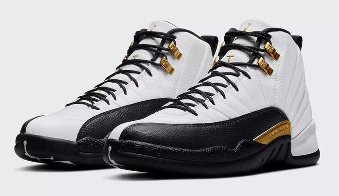 Best Air Jordan 12 colorways "Royalty" product image of a pair of white sneakers with black overlays and gold accents.