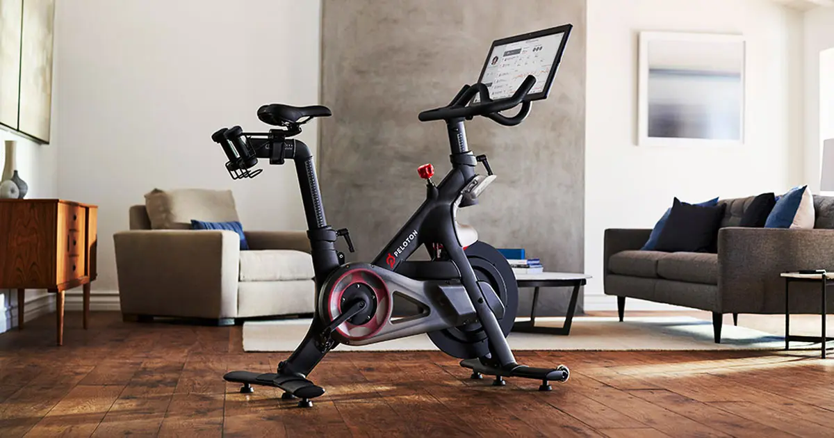 A black exercise bike with a heads-up display and red trim sat in a living room.