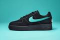Image of a black suede Nike Air Force 1 featuring a Tiffany blue Swoosh.