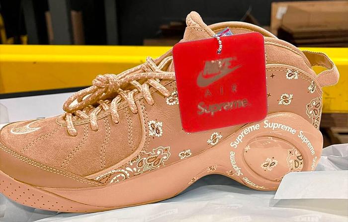 Supreme x Nike Zoom Flight 95 product image of a cream sneaker with a bandana-like pattern across the side and red hang tag.