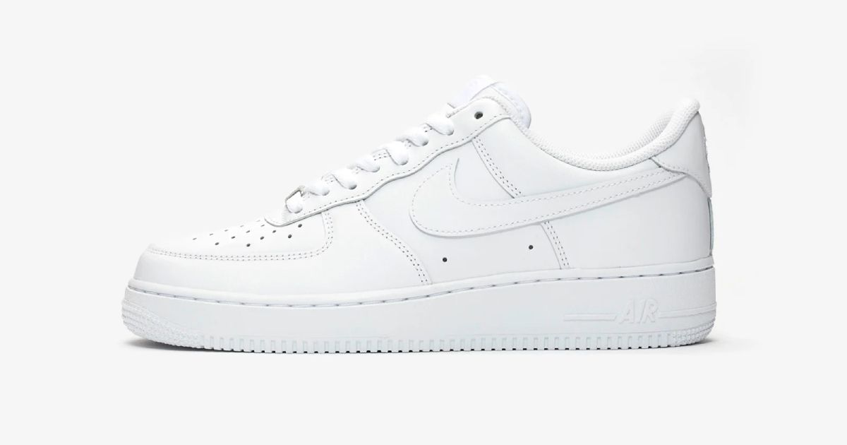 An all-white Nike Air Force 1 low-top in front of a very light grey background.