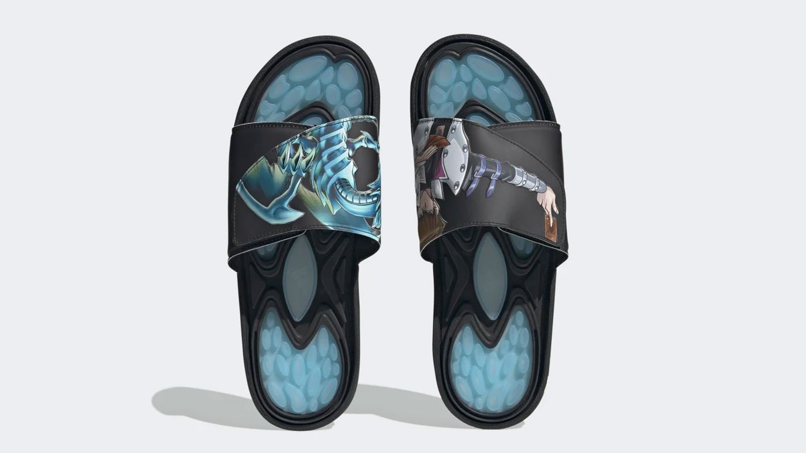 Yu-Gi-Oh! x adidas Reptossage Slides product image of black and light blue sliders with graphics of Seto and Blue Eyes White Dragon on top.