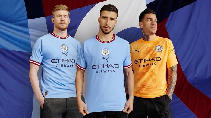 Manchester City PUMA home kit product image of a light blue kit with a burgundy collar and cuffs.