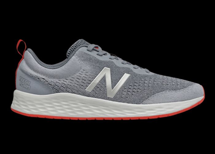 Best running shoes under 100 New Balance product image of a grey, white, and orange shoe.