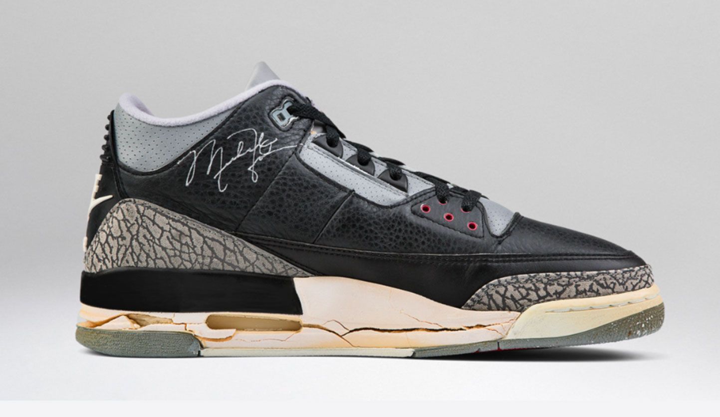 Air Jordan 3 "Black Cement" 1998 product image of a black worn-down sneaker with elephant print mudguards and heels.