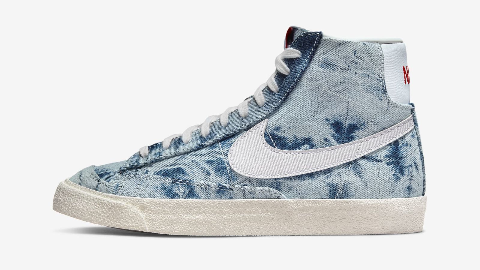 Nike Blazer Mid '77 "Washed Denim" product image of a blue denim-like canvas mid-top Nike featuring a white Swoosh and sole.