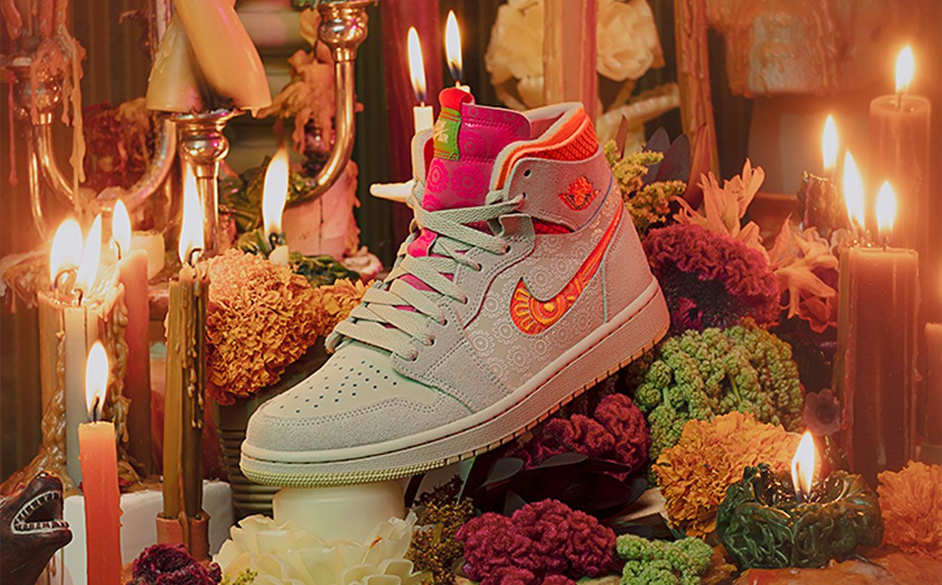Nike Air Jordan 1 "Somos Familia" product image of a rattan and orange sneaker featuring a marigold flower graphic.