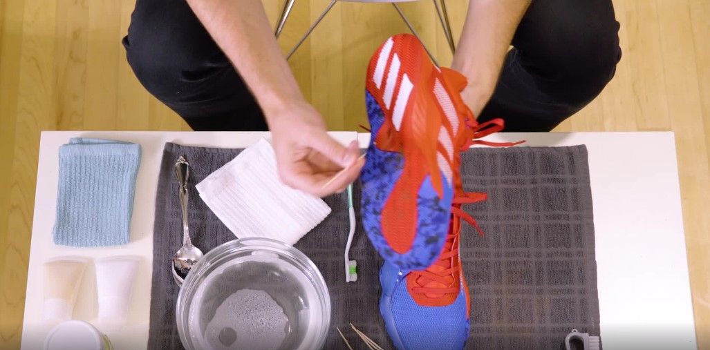 adidas product image removing stones from basketball shoe soles.