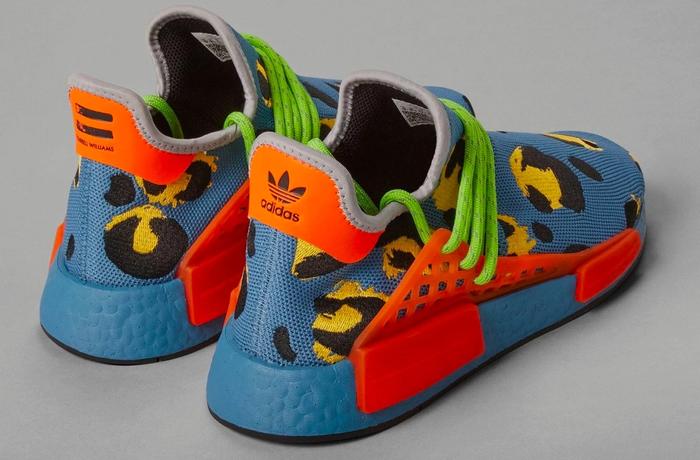 Pharrell x adidas Hu NMD Animal Print Blue product image of a blue sneaker with orange accents, green laces, and yellow and black animal spots.