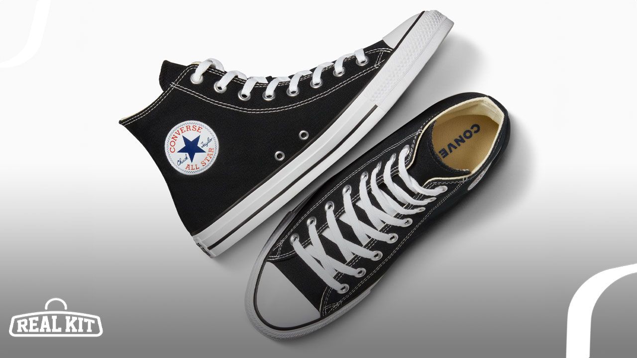 A black canvas pair of Converse high-tops with white laces, soles, and Chuck Taylor branding on the sides.