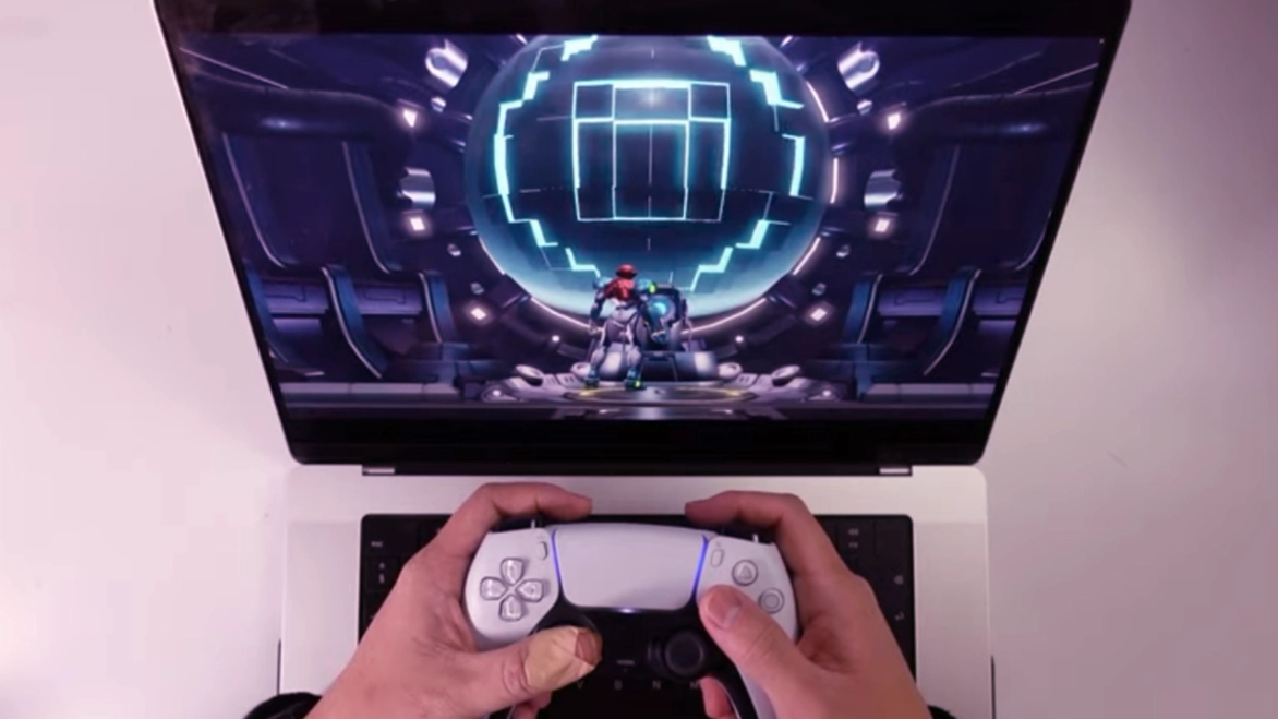 switch emulation runs on macos someone playing metroid dread on a laptop with a PS5 controller