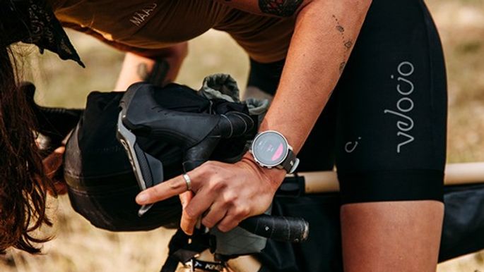 Suunto 9 Peak watch on a cyclist's wrist - Suunto 9 Peak Pro