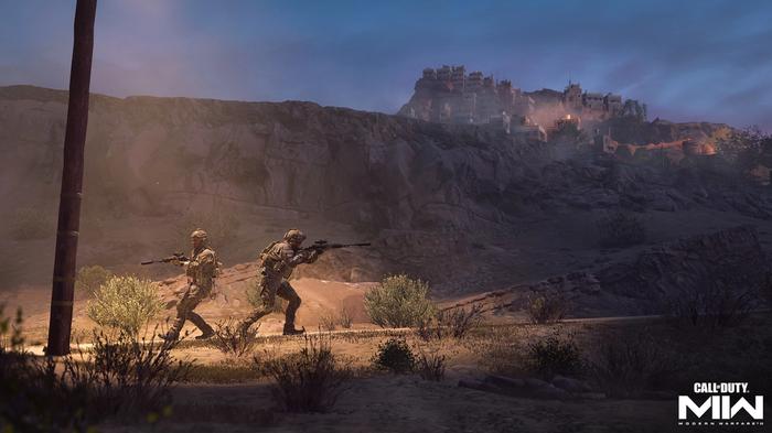 Two soldiers under a street light in a desert. On a hill above them is a settlement - Modern Warfare 2 won't download